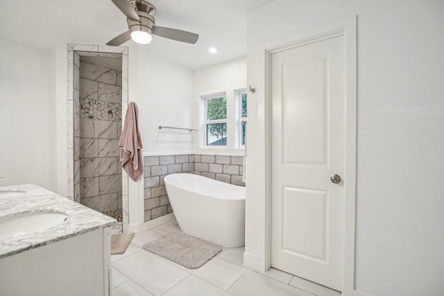 5604 Hudson Bend Rd, Austin, TX 78734 - bathroom with a soaking tub, a tile shower, double vanity, ceiling fan, and tile walls