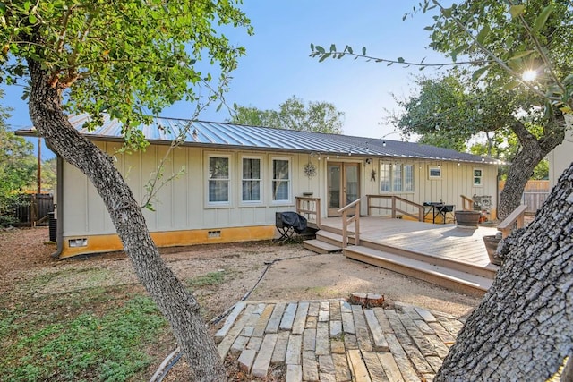 5604 Hudson Bend Rd, Austin, TX 78734 - view of front of home featuring crawl space, a wooden deck, metal roof, and board and batten siding