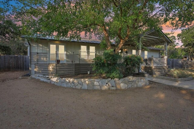 5604 Hudson Bend Rd, Austin, TX 78734 - view of front facade with french doors and board and batten siding