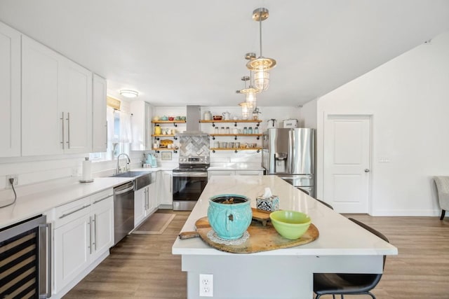 5604 Hudson Bend Rd, Austin, TX 78734 - kitchen with appliances with stainless steel finishes, beverage cooler, island exhaust hood, a sink, and open shelves