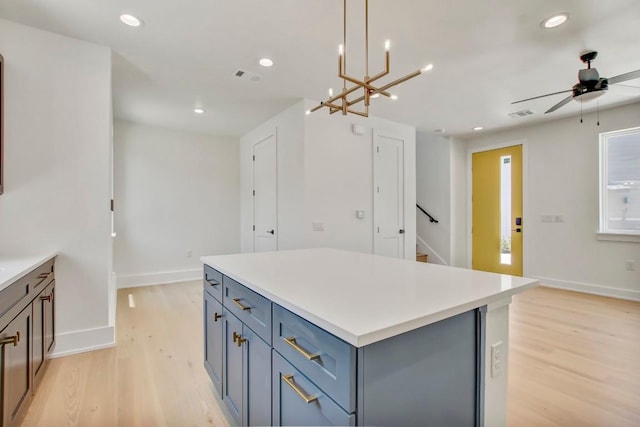 4127 E 12th St Unit 8, Austin, TX 78721 - kitchen featuring light wood-style flooring, a kitchen island, baseboards, a ceiling fan, and recessed lighting