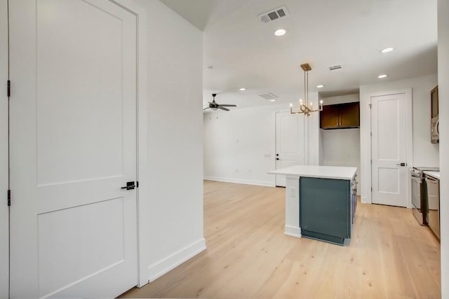 4127 E 12th St Unit 8, Austin, TX 78721 - kitchen featuring baseboards, a center island, light countertops, light wood-style flooring, and recessed lighting