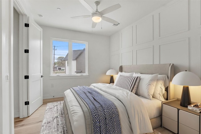 4127 E 12th St Unit 8, Austin, TX 78721 - bedroom featuring light wood-style flooring, baseboards, and a ceiling fan