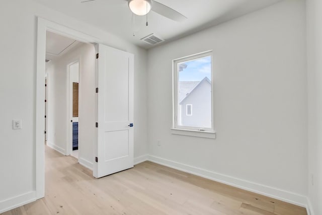 4127 E 12th St Unit 8, Austin, TX 78721 - spare room with attic access, ceiling fan, light wood-style flooring, and baseboards