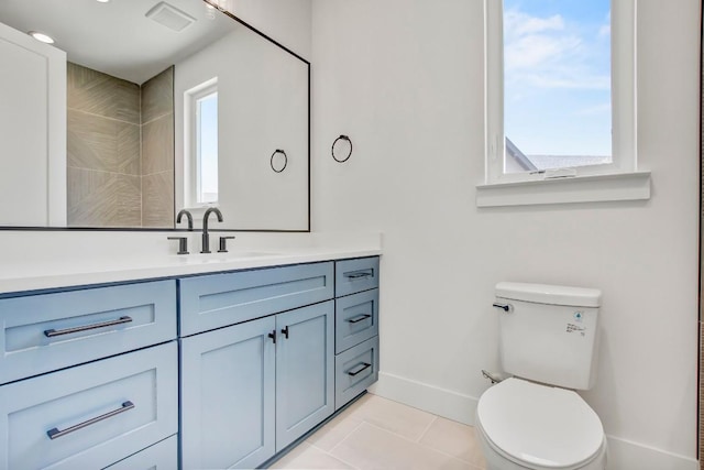 4127 E 12th St Unit 8, Austin, TX 78721 - bathroom with vanity, toilet, baseboards, and tile patterned floors