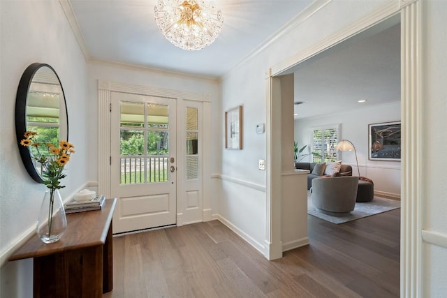 4607 Balcones Dr, Austin, TX 78731 - foyer entrance with crown molding, wood finished floors, and a chandelier
