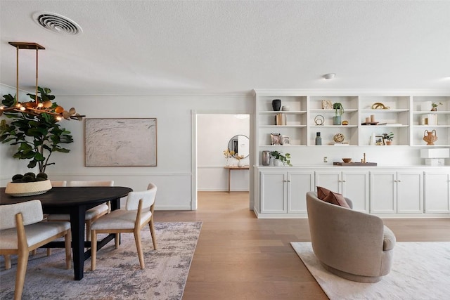4607 Balcones Dr, Austin, TX 78731 - dining room with light wood-type flooring and a textured ceiling