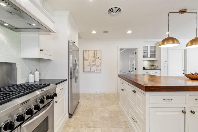 4607 Balcones Dr, Austin, TX 78731 - kitchen featuring wall chimney exhaust hood, butcher block countertops, appliances with stainless steel finishes, backsplash, and white cabinetry