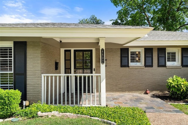 4607 Balcones Dr, Austin, TX 78731 - view of exterior entry with brick siding and roof with shingles