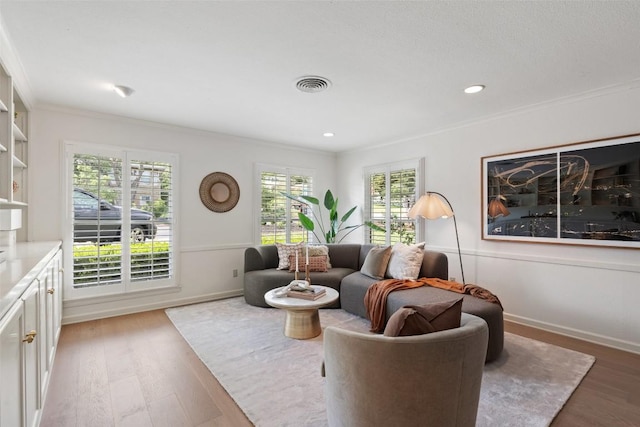 4607 Balcones Dr, Austin, TX 78731 - living room with light wood-style floors, crown molding, and recessed lighting