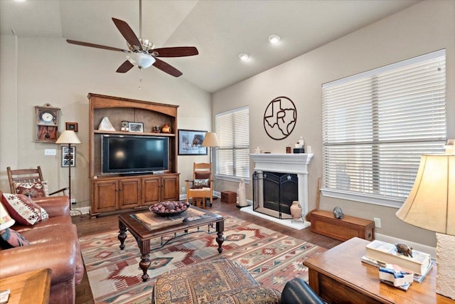 21912 Rock Wren Rd, Spicewood, TX 78669 - living area with a ceiling fan, lofted ceiling, wood finished floors, and a fireplace with raised hearth