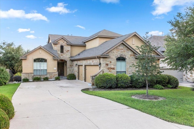 21912 Rock Wren Rd, Spicewood, TX 78669 - french country home with stone siding, concrete driveway, a front lawn, stucco siding, and an attached garage