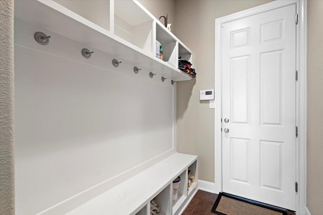 21912 Rock Wren Rd, Spicewood, TX 78669 - mudroom with dark wood-style floors and baseboards