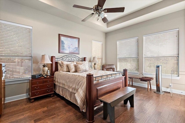 21912 Rock Wren Rd, Spicewood, TX 78669 - bedroom with baseboards, dark wood-style floors, and multiple windows