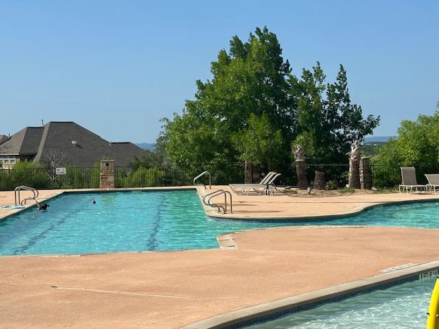 21912 Rock Wren Rd, Spicewood, TX 78669 - community pool featuring a patio