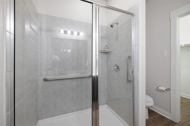 129 Syrah Ct, Leander, TX 78641 - full bathroom featuring toilet, a stall shower, wood finished floors, and baseboards