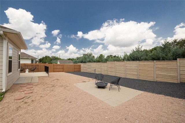 129 Syrah Ct, Leander, TX 78641 - fenced backyard with a patio and a fire pit