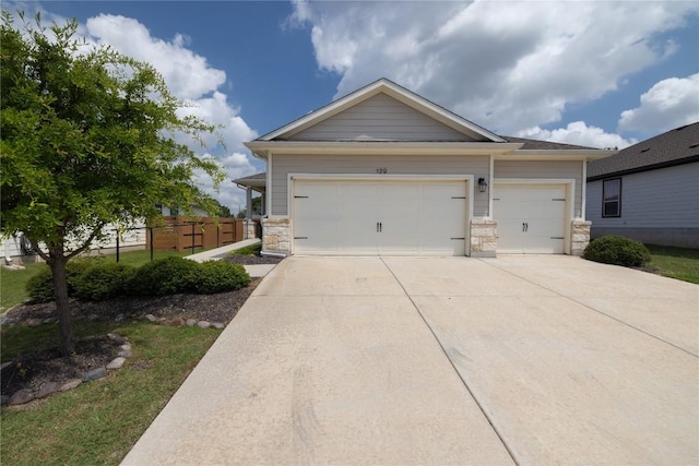129 Syrah Ct, Leander, TX 78641 - view of front of house with stone siding, concrete driveway, and an attached garage