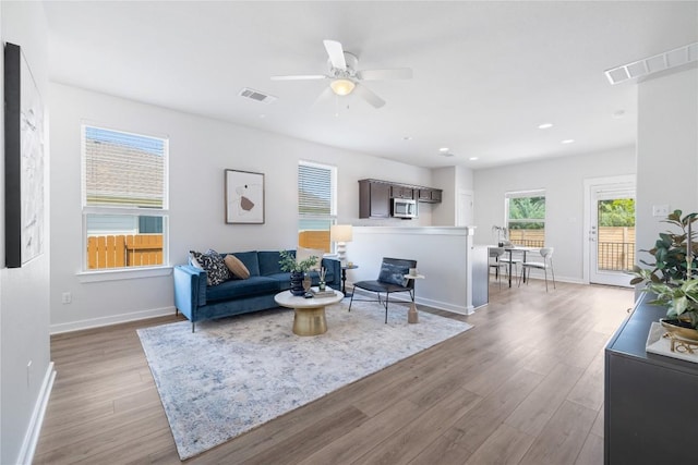 129 Syrah Ct, Leander, TX 78641 - living area featuring wood finished floors, a ceiling fan, baseboards, and recessed lighting