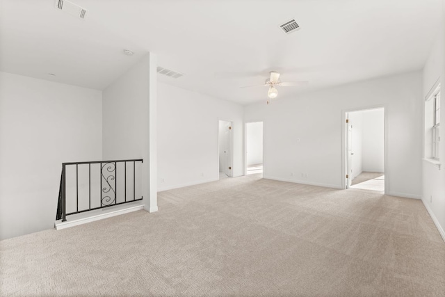 5913 N W Pl, Austin, TX 78731 - spare room featuring ceiling fan, light carpet, and baseboards