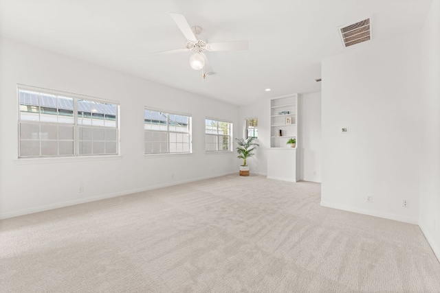 5913 N W Pl, Austin, TX 78731 - spare room featuring light colored carpet, baseboards, a ceiling fan, recessed lighting, and built in features