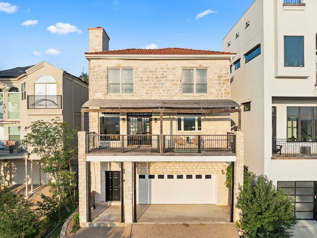 5913 N W Pl, Austin, TX 78731 - back of property featuring a chimney, a balcony, an attached garage, and driveway