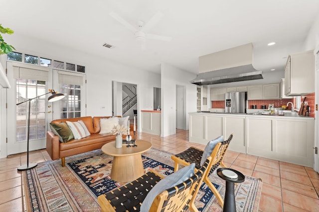 5913 N W Pl, Austin, TX 78731 - living area featuring light tile patterned floors, a ceiling fan, and stairs