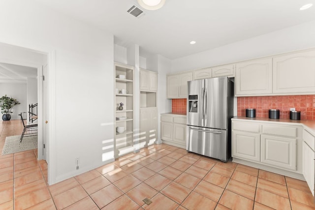 5913 N W Pl, Austin, TX 78731 - kitchen featuring stainless steel refrigerator with ice dispenser, tasteful backsplash, light countertops, light tile patterned floors, and recessed lighting