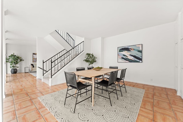 5913 N W Pl, Austin, TX 78731 - dining room featuring stairway, light tile patterned floors, and baseboards