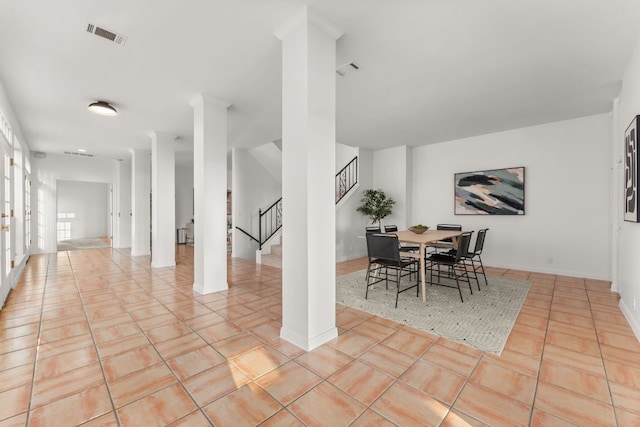 5913 N W Pl, Austin, TX 78731 - dining space featuring stairway, light tile patterned floors, and baseboards