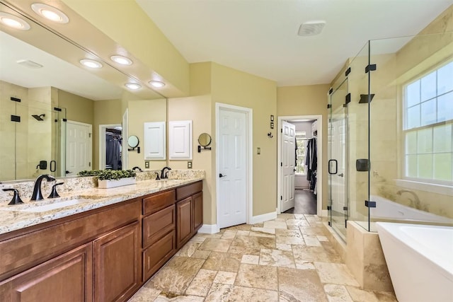 10672 Bramblecrest Dr, Austin, TX 78726 - bathroom with a stall shower, a walk in closet, a freestanding bath, stone tile floors, and double vanity