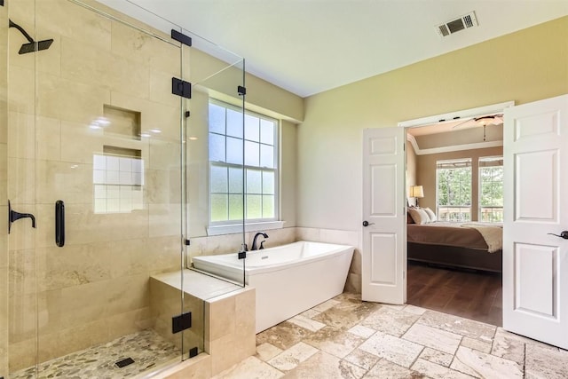 10672 Bramblecrest Dr, Austin, TX 78726 - ensuite bathroom with a freestanding bath, a shower stall, and stone tile flooring
