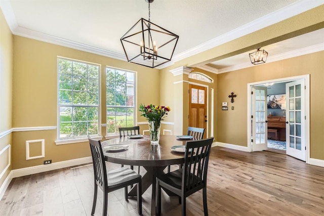 10672 Bramblecrest Dr, Austin, TX 78726 - dining space with a chandelier, baseboards, wood finished floors, and ornamental molding