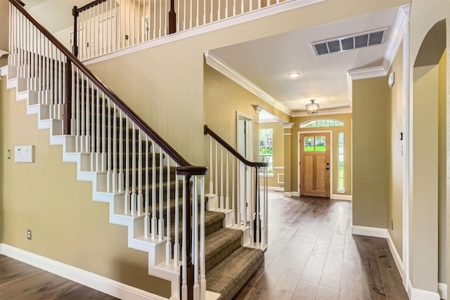 10672 Bramblecrest Dr, Austin, TX 78726 - entrance foyer with ornamental molding, wood-type flooring, stairs, and baseboards
