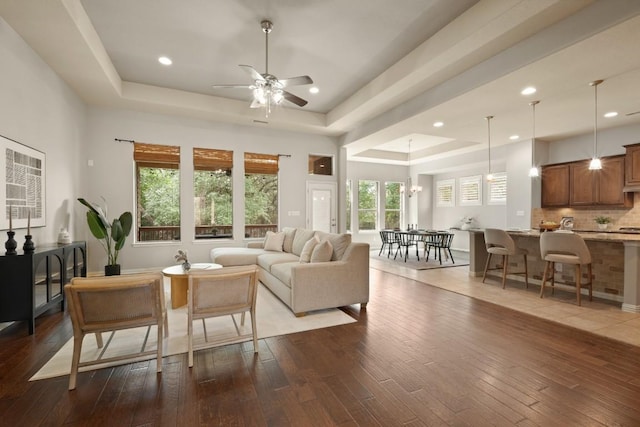 495 Catalina Ln, Austin, TX 78737 - living area with a tray ceiling, ceiling fan, dark wood-style flooring, recessed lighting, and a chandelier