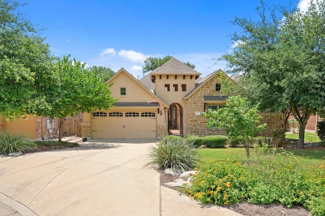 495 Catalina Ln, Austin, TX 78737 - view of front of home with an attached garage, concrete driveway, stucco siding, and stone siding