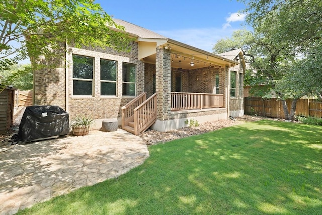 495 Catalina Ln, Austin, TX 78737 - back of property featuring brick siding, a patio, and a porch