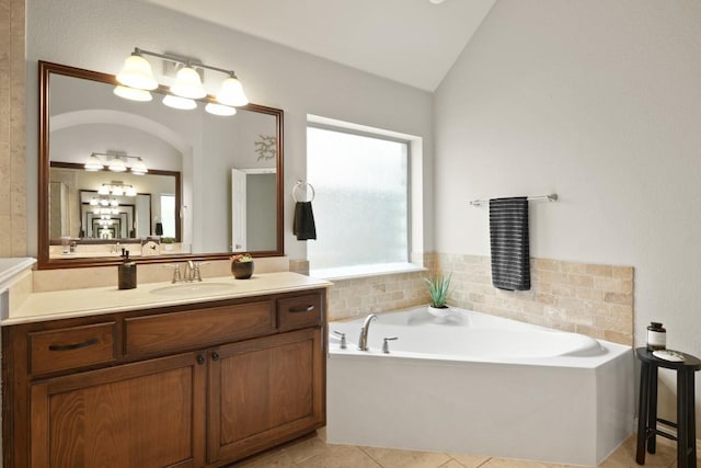 495 Catalina Ln, Austin, TX 78737 - full bath featuring lofted ceiling, vanity, a garden tub, and tile patterned floors