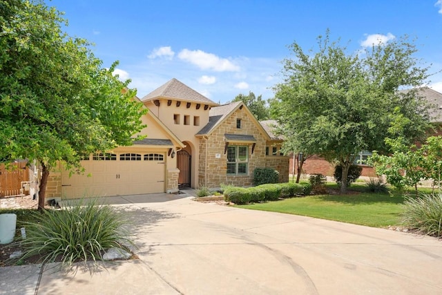 495 Catalina Ln, Austin, TX 78737 - view of front facade featuring stone siding, a garage, concrete driveway, stucco siding, and a front yard