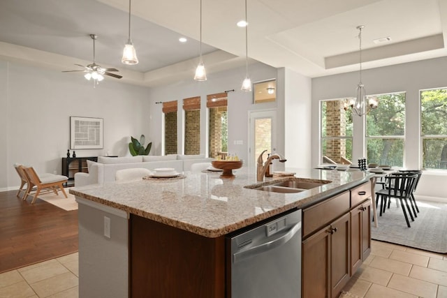 495 Catalina Ln, Austin, TX 78737 - kitchen featuring a tray ceiling, stainless steel dishwasher, a sink, a center island with sink, and recessed lighting