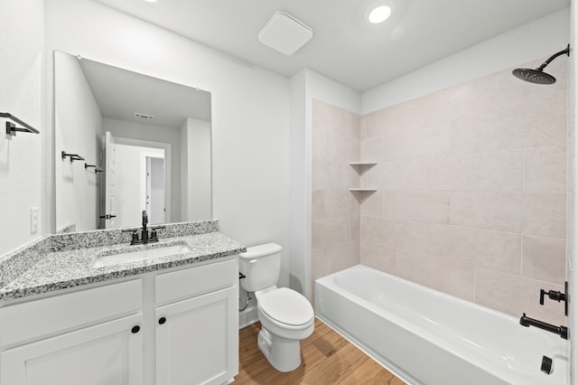 9312 Gladsome Path, Manor, TX 78653 - bathroom with toilet, vanity, wood finished floors, and bathing tub / shower combination