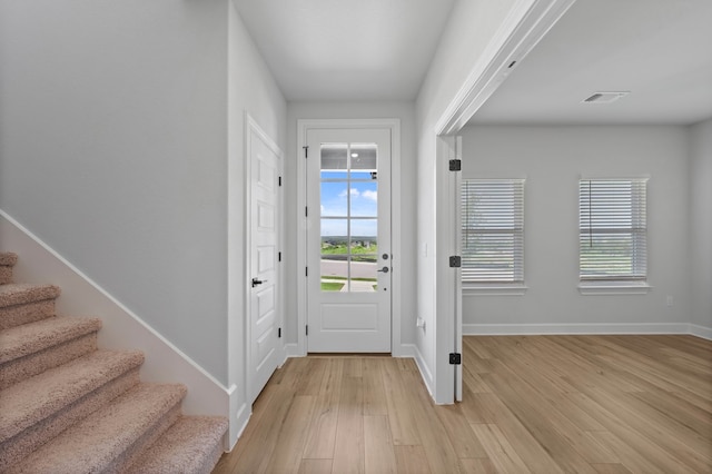 9513 Balmy Ln, Manor, TX 78653 - entrance foyer featuring light wood-type flooring, stairs, and baseboards
