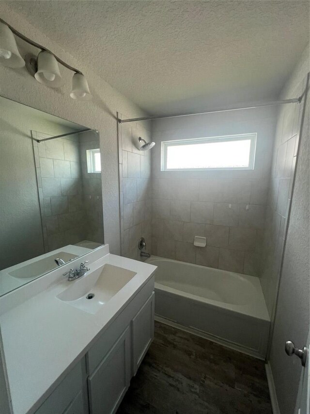 2425 Arctic Warbler, New Braunfels, TX 78130 - bathroom featuring wood finished floors, a textured ceiling, shower / tub combination, and vanity