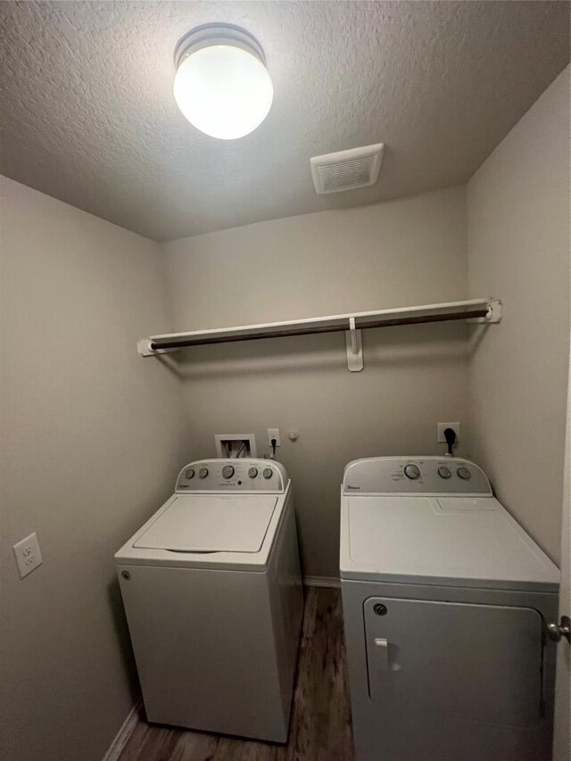 2425 Arctic Warbler, New Braunfels, TX 78130 - laundry area with washer and dryer, dark wood-type flooring, and a textured ceiling