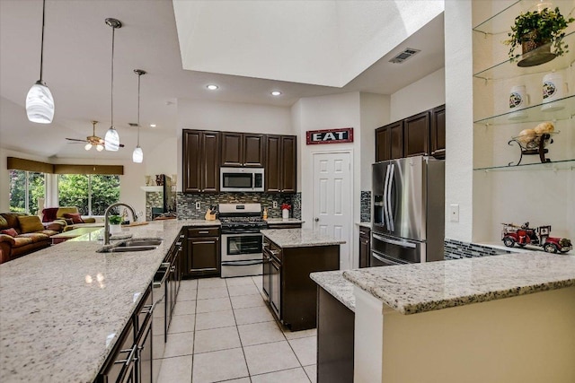 5801 Taylor Draper Cv, Austin, TX 78759 - kitchen featuring stainless steel appliances, a peninsula, tasteful backsplash, open floor plan, and dark brown cabinetry