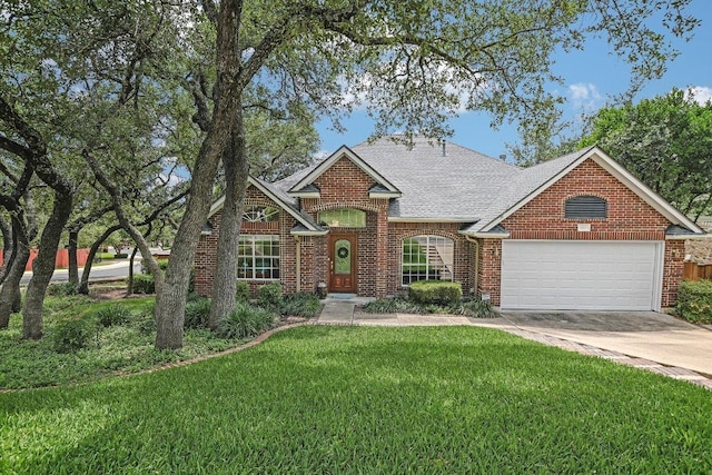 5801 Taylor Draper Cv, Austin, TX 78759 - traditional home featuring a garage, a front yard, brick siding, driveway, and a shingled roof
