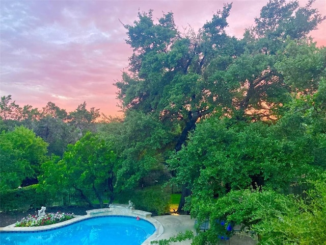 5801 Taylor Draper Cv, Austin, TX 78759 - pool at dusk featuring an outdoor pool