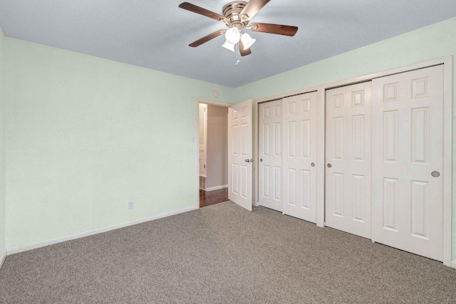 7105 Creighton Ln, Austin, TX 78723 - unfurnished bedroom with carpet flooring, two closets, baseboards, and a ceiling fan