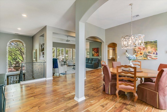 12505 Stapp Ct, Austin, TX 78732 - dining space with arched walkways, a chandelier, light wood finished floors, recessed lighting, and baseboards