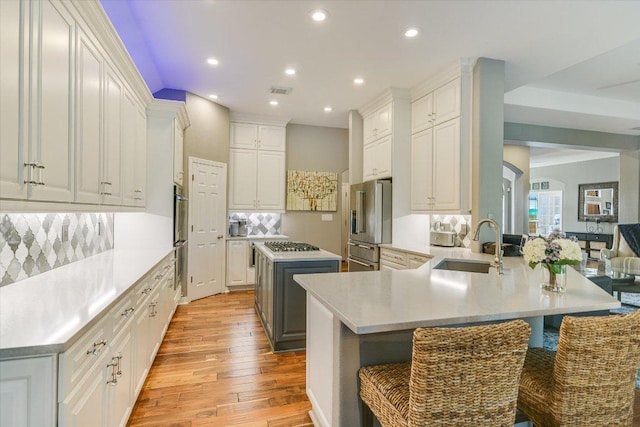 12505 Stapp Ct, Austin, TX 78732 - kitchen featuring gas cooktop, recessed lighting, high end refrigerator, light wood-style floors, and decorative backsplash